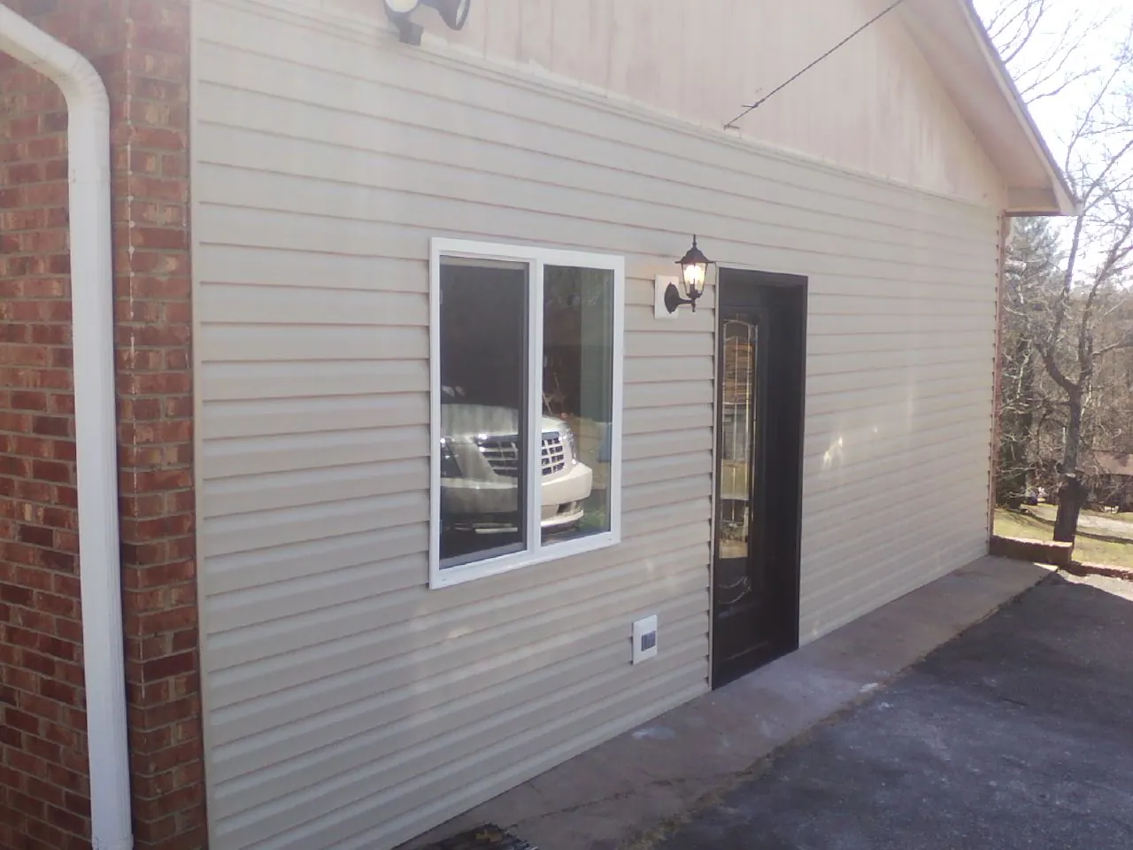 New vinyl siding and entry door on a room addition in Farrell